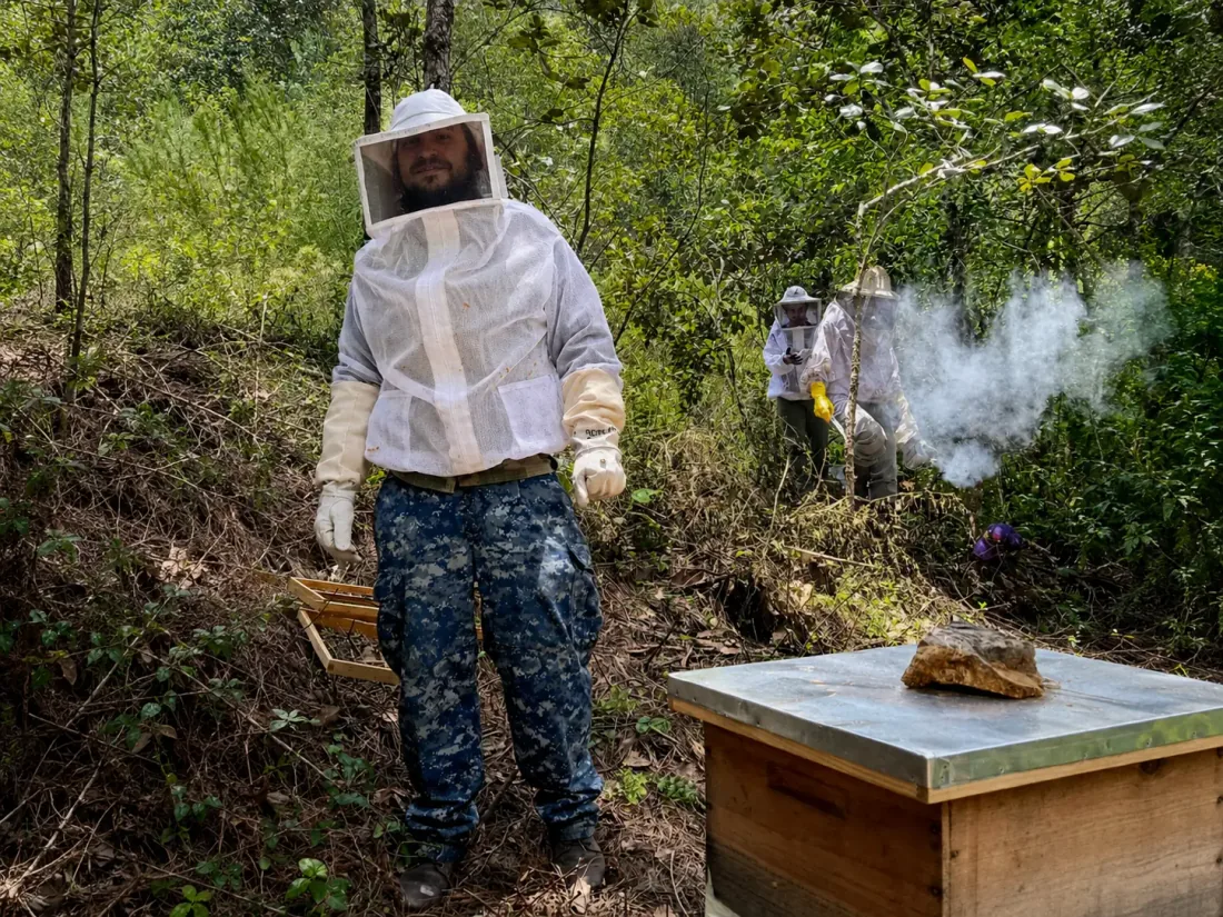Josh Marx Dyer in protective beekeeping gear during pollinator conservation work in Mexico.